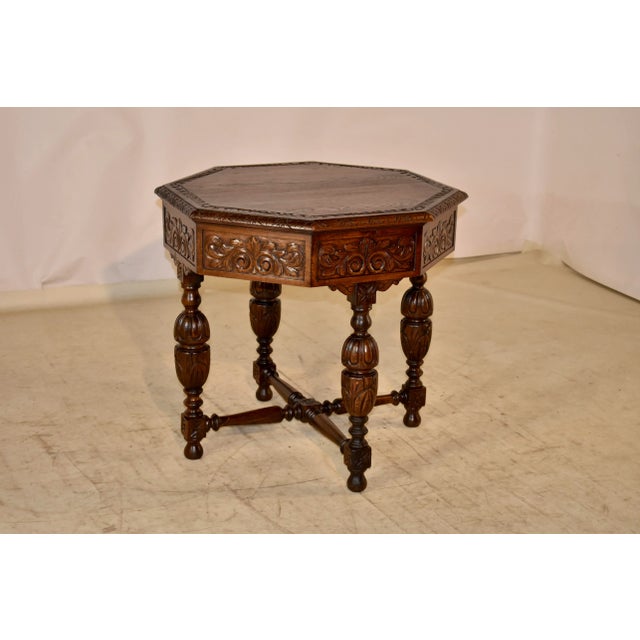 19th century oak side table from France with an octagonal shaped top. The top has a carved decorated band inside a beveled...