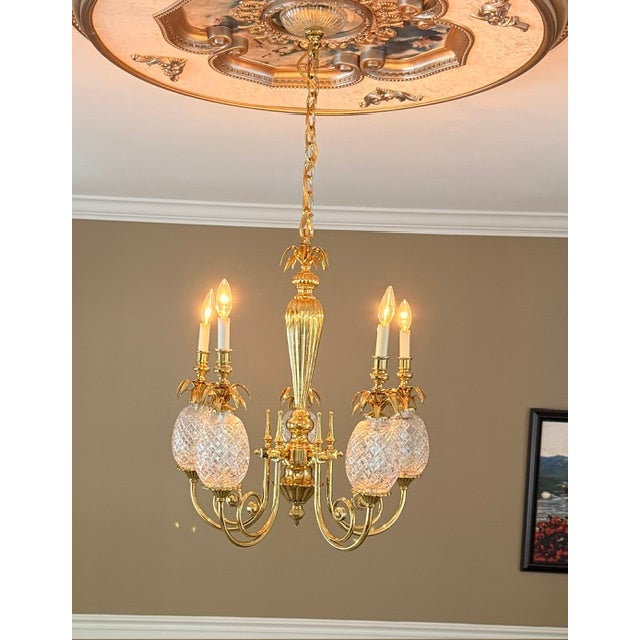 Gorgeous 5-arm hospitality chandelier, featuring pineapple-shaped, precision cut, clear crystal motif on polished brass...