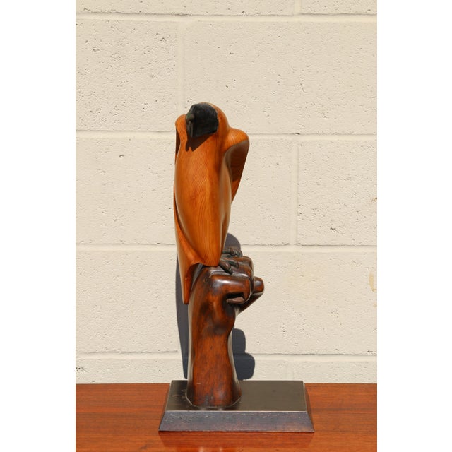 An exceptional vintage sculptural piece by Sarreid Ltd., Made in Spain, featuring a hooded falcon perched atop a...