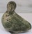 Signed in Inuit syllabics on the underside, this mid-century Inuit soapstone bird sculpture has a softly stylized bird...