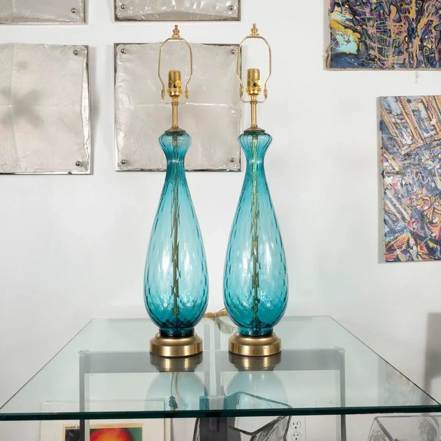 Pair of pale blue Murano glass lamps with fine patterned fluting and brass hardware.