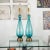 Pair of pale blue Murano glass lamps with fine patterned fluting and brass hardware.