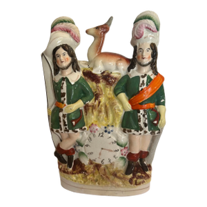 Antique Staffordshire Figurine Depicting 2 Hunters With Plumed Hats, a Bow, a Deer on Top and a Clock at the Bottom.