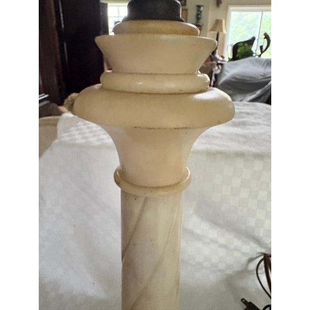 An Italian alabaster column lamp from the 1940's. The lamp is vintage, carved Italian alabaster featuring a neoclassical...
