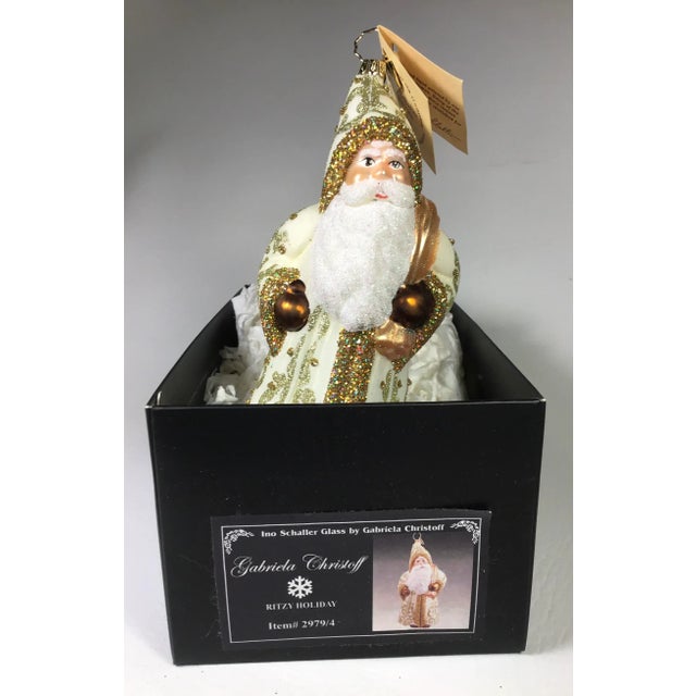 Ino Schaller has been producing Paper Mache Santa Candy Containers since 1869. This beautiful Santa Ornament was derived...