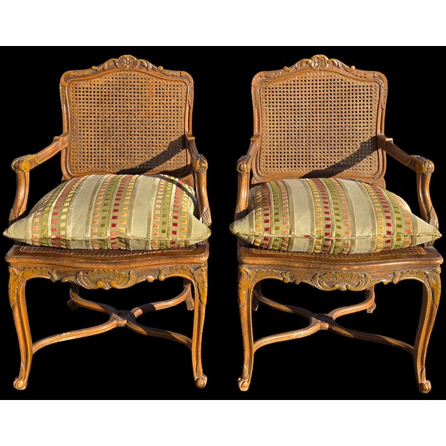 Elegant pair of French Louis XV style fauteuil armchairs crafted in carved walnut, dating to the Late 19th to Early 20th...