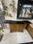 Warm-toned wood cabinet featuring paneled doors, carved details, and dual drop-leaf extensions that create a generous...