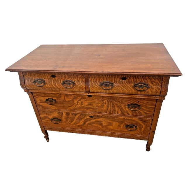 Gorgeous late 19th-to-early 20th-century American antique chest of drawers. Expertly crafted from richly figured quarter-...