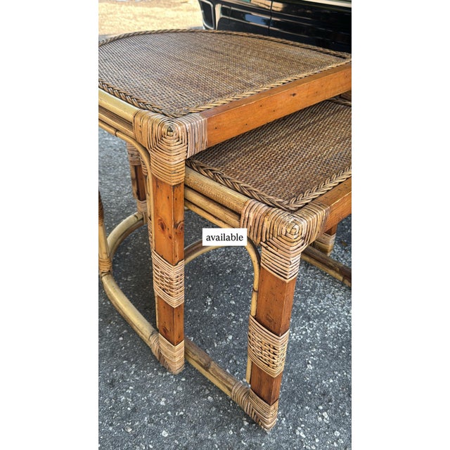 Charming vintage set of two nesting side tables crafted from natural bamboo and woven wicker/rattan. Featuring rounded...