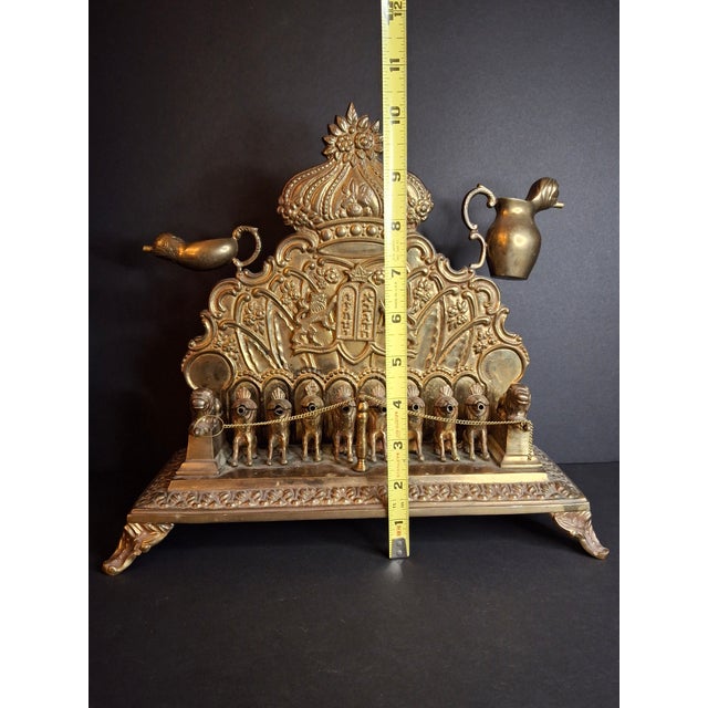 Presenting a museum-grade antique European cast brass Chanukah oil lamp, dating from the late 19th to early 20th century....