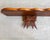 This handcrafted, one-of-a-kind wall-mounted wood shelf features a scalloped edge and two large bow brackets below the...