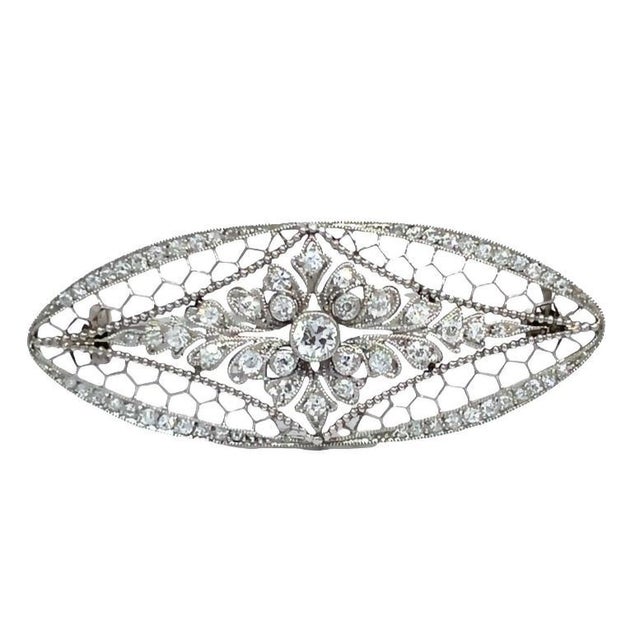 Elevate your accessory collection with this exquisite vintage diamond brooch, a timeless piece crafted from luxurious...