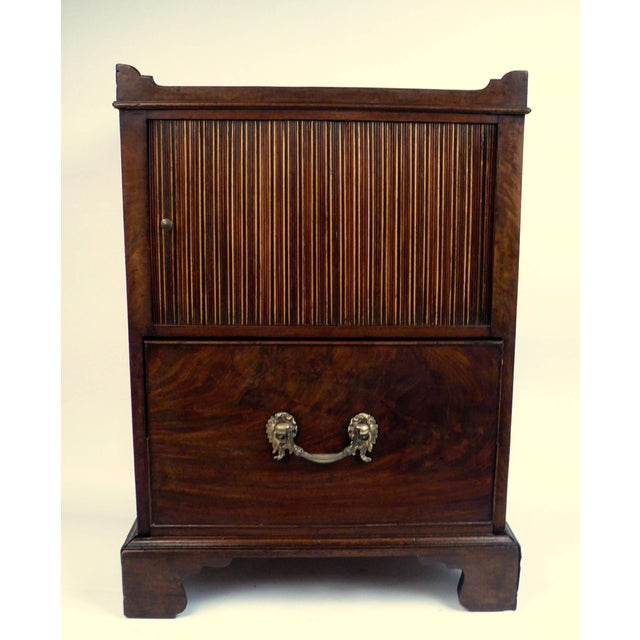 This extra fine quality bedside commode has a lovely old color and patina. It features cut out handles above a plum...