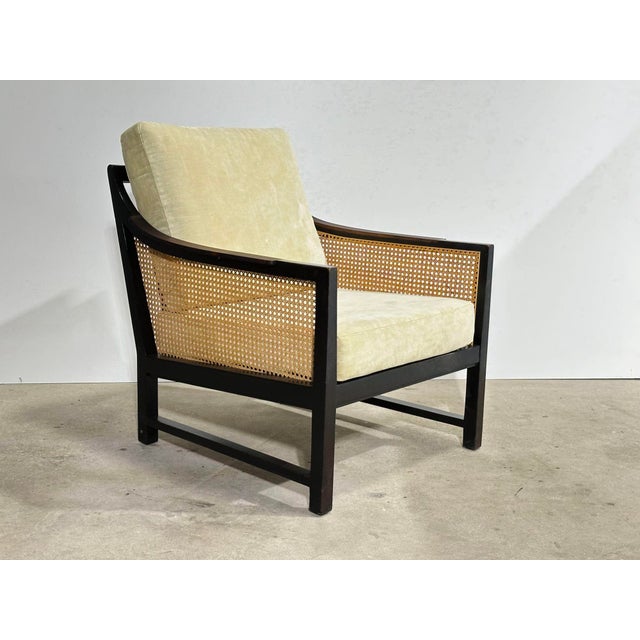 Mahogany and Cane Lounge Chair by Edward Wormley for Dunbar, 1950’s. The armrests are rosewood. Measures 26” wide 30.5”...
