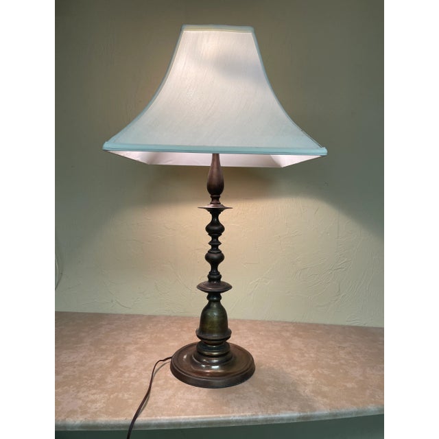 Sophisticated solid bronze candle style lamp. It is in perfect working order. Fabulous patina. Between the invention the...