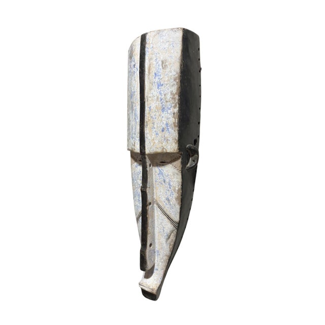 Superb vintage Fang mask carved from a single piece of heavy wood, featuring an elongated heart-shaped face rendered in...