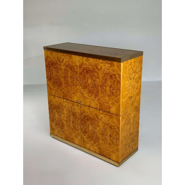A really exclusive bar cabinet in high quality burlwood veneer and brass details. This cabinet is completly restored and...