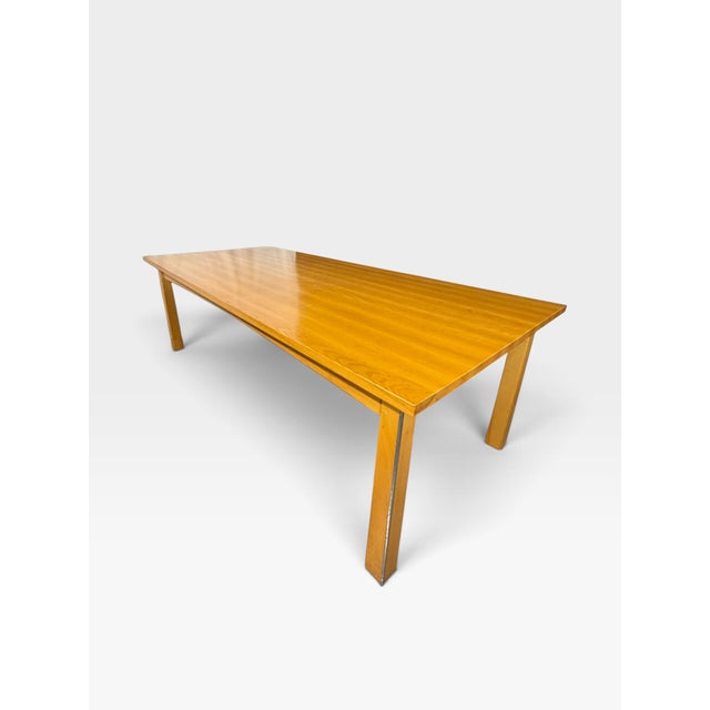Neil Rymer (b.1964) dining suite, c.2002, ash and nickel plate, the chairs upholstered with brown leather seat pads,...