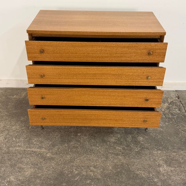 This is a Paul McCobb Irwin Collection four-drawer chest or dresser for Calvin Furniture, made of mahogany with a brass...