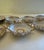 A distinguished set of six double-handled bouillon cups and five matching saucers in fine white Limoges porcelain, bearing...