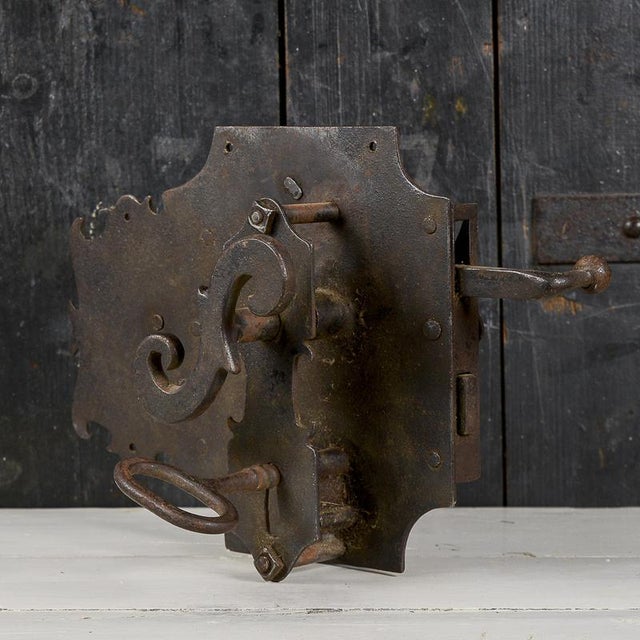 This vintage wrought-iron lock is a fascinating example of technical antiques and historic hardware. The piece stands out...