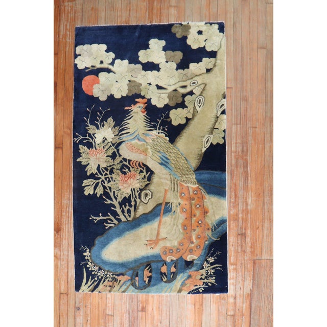A fine quality antique Tibetan accent size rug depicting a large rooster on a navy blue ground. Measures: 3'9" x 6'