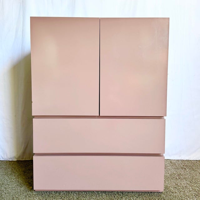 A striking example of Postmodern minimalism, this mauve pink laminate armoire offers both style and function with clean...