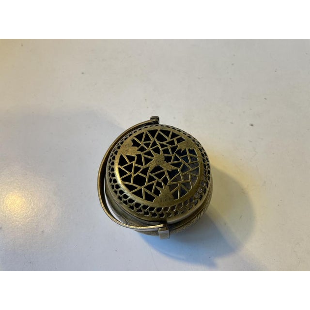 A signed ceremonial incense burner in hand-edged brass. Decorated with Komainu Japanese for Foo dog/lion to both sides. It...