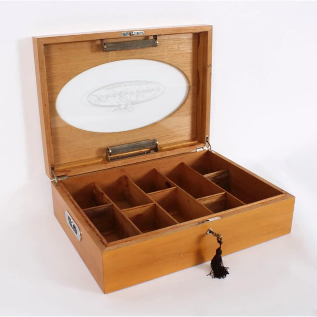 An elegant Vintage English fruitwood humidor with fitted interior, mid 20th century in date. The rectangular humidor...