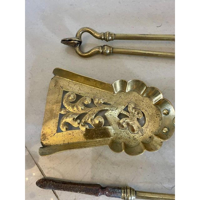 Set of antique Victorian quality brass fire irons consisting of an ornate decorative shovel, poker and fire tongs with...