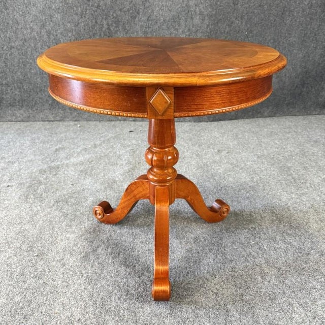 The Hammary American Heritage round lamp table showcases a warm wood finish with a beautifully patterned radial veneer top...