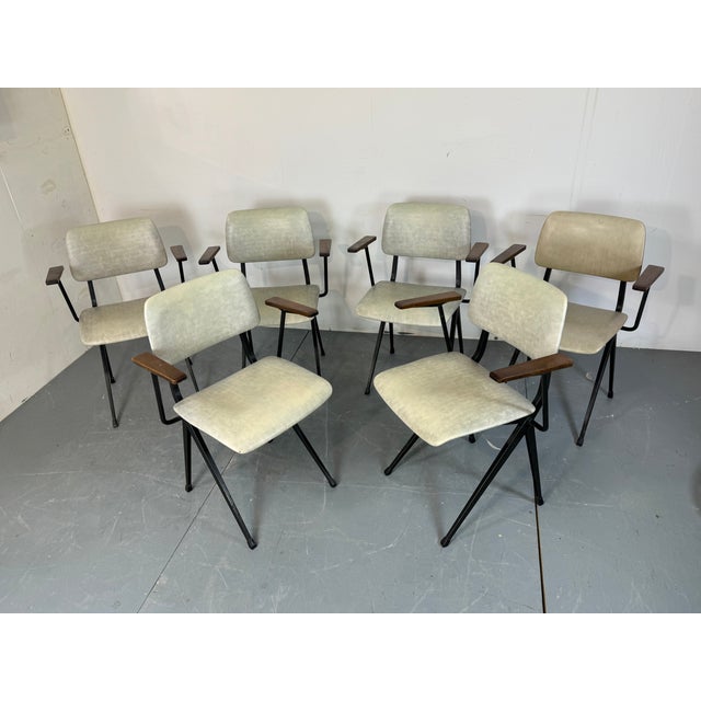 Set of 6 industrial steel chairs with wooden armrests manufactured by Marko in Holland during the 1960s. The chairs have a...