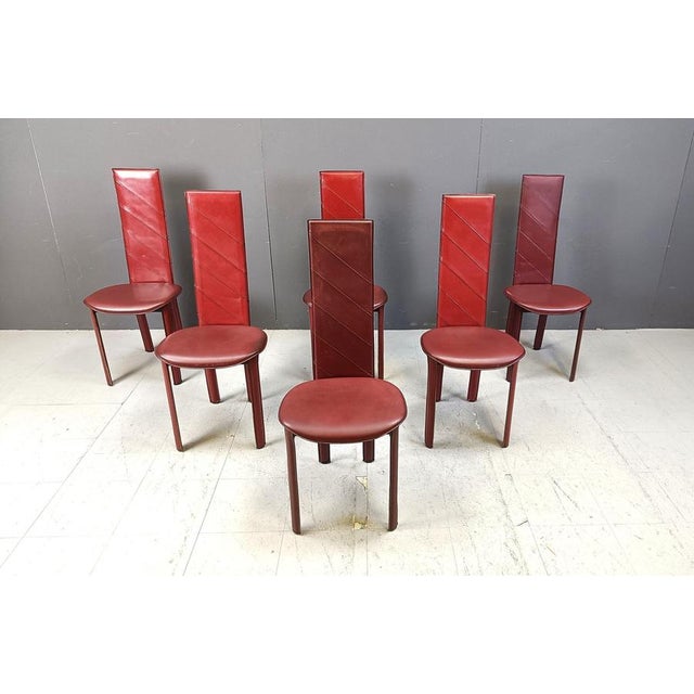 Set of 6 dark red italian leather high back dining chairs. beautiful sleek and timeless design with nice stitches across...