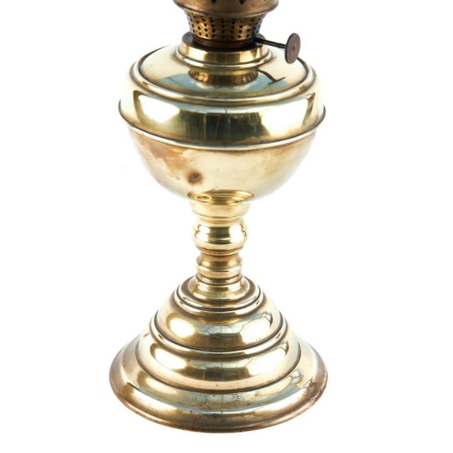 For sale is this 19th Century antique brass oil lamp, with glass chimney, Lovely shaped brass font supported by a stepped...