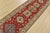 A tribal Caucasian Kazak runner hand-knotted with fine wool on a cotton foundation. This rug features a row of geometric...