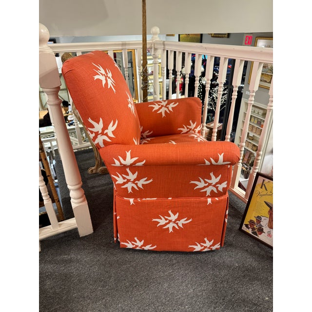 This is a vintage club chair. It has a new designers fabric. It depicts white swans on a burnt orange background. It has...