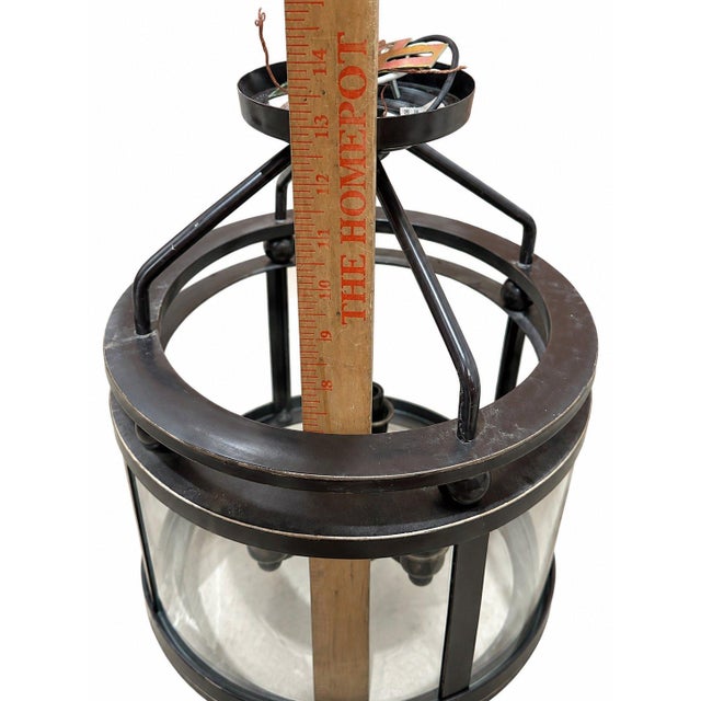 11.4" Depth 11.4" Width 13.2" Leight A striking lantern-style ceiling light featuring a black metal frame with clear...
