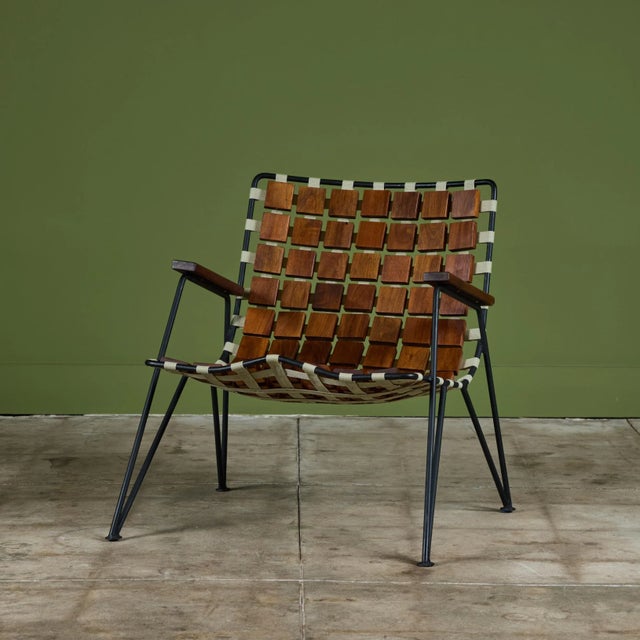 Lounge chair designed by Maxwell Yellen in 1954. The lightweight wire frame has strapping along the seat and seat back,...