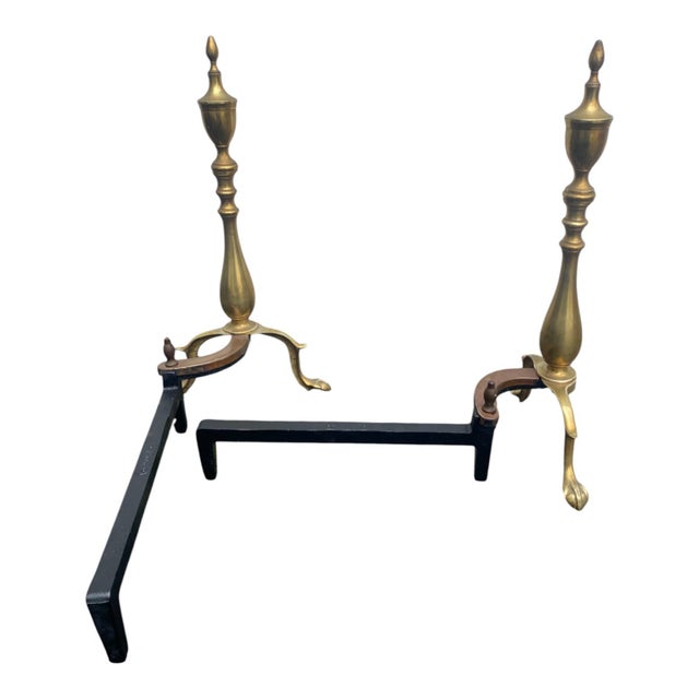 Pair of vintage 1920s brass andirons in the Chippendale style featuring elegant finials and classic claw and ball feet....
