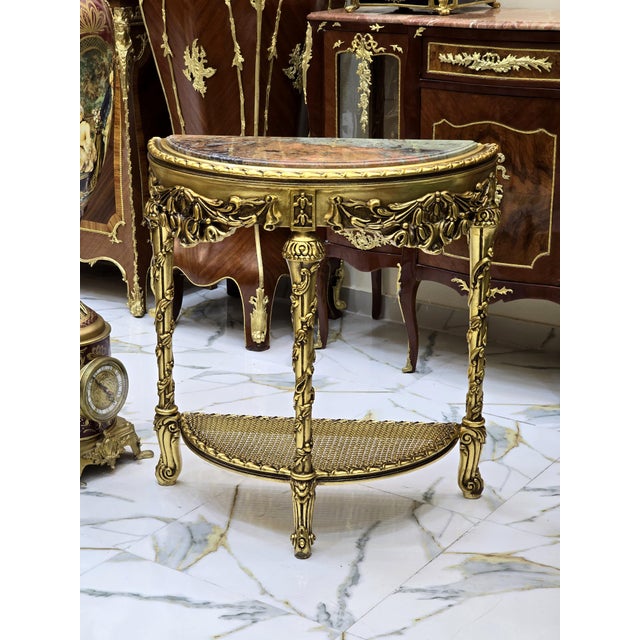 Beautiful large console with a light color marble top. This item has been fully refinished in new gold leaf. Stunning...