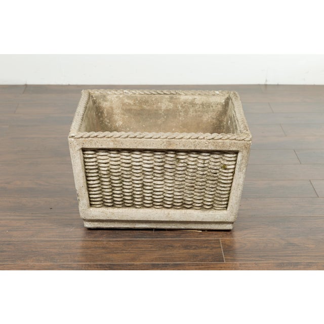 A vintage English stone planter from the mid 20th century, with textured finish and moss. Created in England during the...
