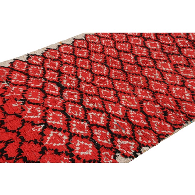 Hand-knotted in wool and originating from Morocco circa 1950-1960, this 4x7 vintage Moroccan rug is an extremely rare...