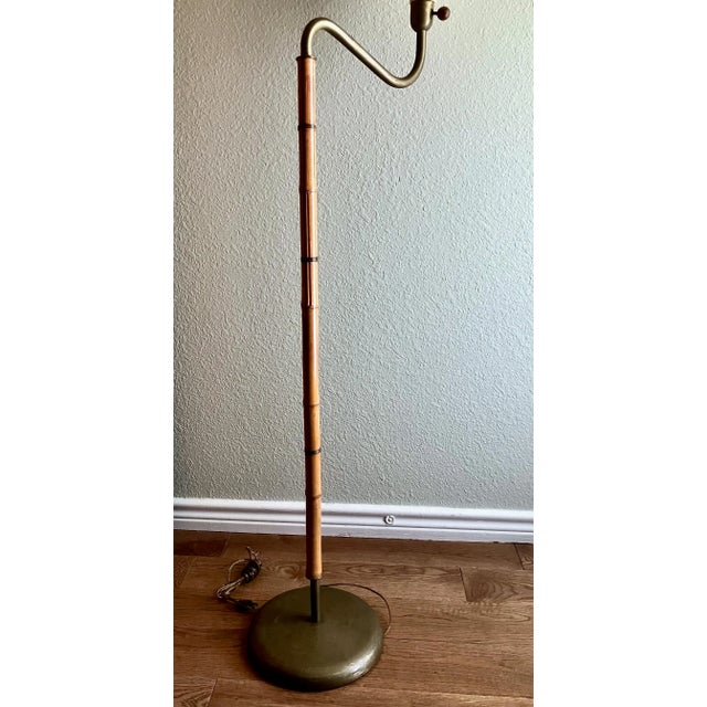 Magnificent and rare Russel Wright, NYC bamboo and spun brass curved-neck floor lamp. Lamp retains original distinctive...