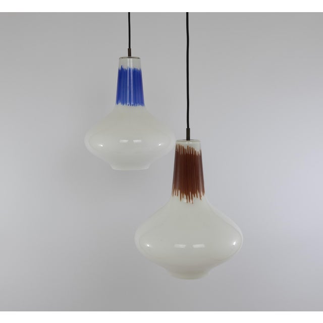 Hand-blown No. 011.13 glass pendants with red and blue, designed by Massimo Vignelli at the start of his impressive career...