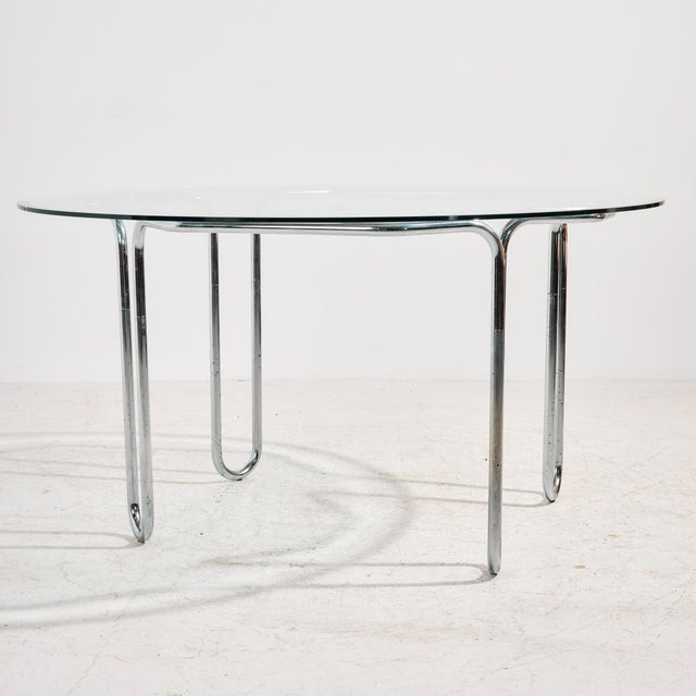 Italian chrome dining set from the 1980s. The set consists of six chairs and one dining table. The chair’s cantilever base...