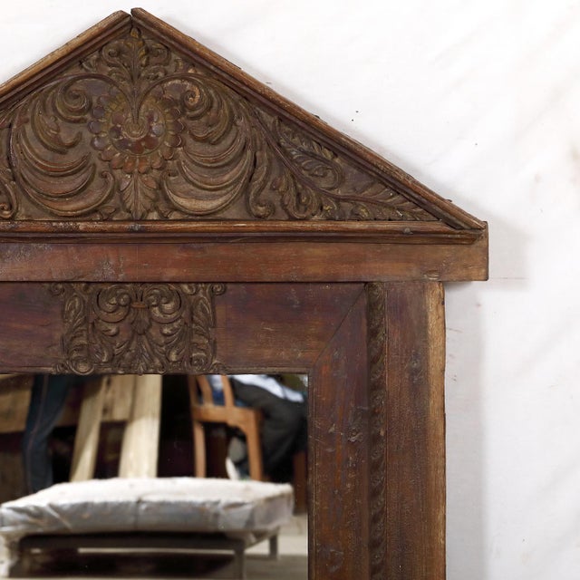 The crisply carved frame and pediment was originally a Rajasthani window and would have held small shutters inside. In a...