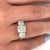4.83 carat total cushion cut lab grown diamond three stone ring. Set in a 14k yellow gold shank and platinum basket with...
