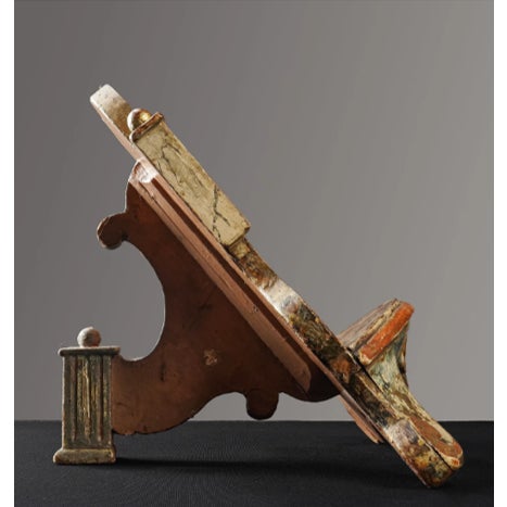 A richly decorative antique book stand crafted from carved wood and finished in original polychrome with gilt accents....