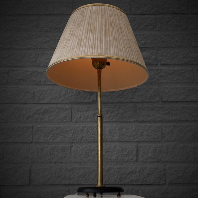 A table lamp, model 15505, designed by Harald Notini for the renowned Swedish manufacturer Arvid Böhlmarks Lampfabrik in...