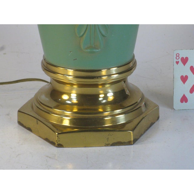 A Hollywood Regency Style Table Lamp. It is a vintage piece and is of a medium size, with an electric power cord source....